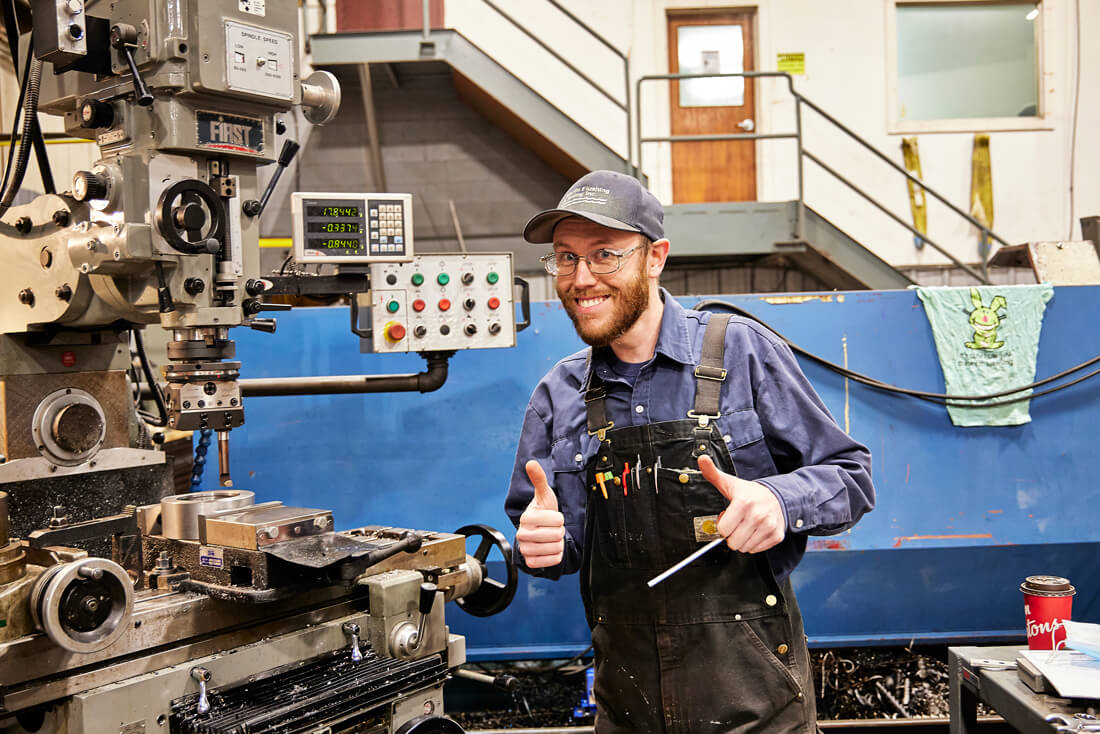 Worker at Atlantic Flushing smiling and giving a thumbs up